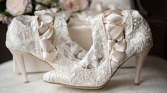 Classic Ivory Lace Wedding Boots and Shoes - House of Elliot Feminine Fitted Wedding Shoes With Almond Toe, Elegant Wedding Heels With Lace Trim, Elegant Laced Wedding Shoes For Ceremony, Elegant Wedding Shoes With Laces For Ceremony, Elegant White Party Boots, Elegant Wedding Shoes With Lace Trim, Elegant Lace Wedding Shoes For Ceremony, Elegant Wedding Shoes With Laces, Elegant Low Heel Wedding Shoes With Lace Trim