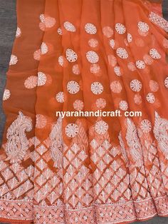 Beautiful Chikankari (famous hand embroidery style from Lucknow, City of Nawabs, India) on georgette. Beautifully embroidered heavy border and palla on this peahy orange saree. Craftsmanship at its best ! FALL ATTACHED AND PETTICOAT INCLUDED ! Includes an embroidered blouse piece too. Orange Georgette Sharara For Navratri, Orange Georgette Sharara With Traditional Drape, Orange Georgette Sharara With Zari Work, Orange Georgette Sharara For Festivals, Designer Orange Sharara With Chikankari Embroidery, Orange Chikankari Embroidery Sharara For Navratri, Orange Chikankari Embroidered Sharara For Navratri, Navratri Georgette Sharara With Motifs, Orange Georgette Traditional Wear For Eid