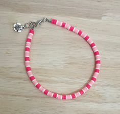 "Add that extra pop to any outfit this summer with this bright coral pink anklet! The anklet is made with an array of coral pink colored polymer beads and finished with a charm of your choice! Colors may vary from image. The anklet is available in a variety of sizes, just message me for custom sizes or an adjusted extender length! There is a size for everyone! :)  * All anklet sizes selected from the drop down menu are the size of the anklet without the 1/4\" chain extender. When selecting a siz Cheap Pink Anklets For Festivals, Cheap Pink Round Beads Anklets, Casual Pink Anklets For Summer, Casual Pink Anklet For Summer, Pink Tiny Beads Anklets For Summer, Pink Anklets With Tiny Beads For Summer, Adjustable Coral Beaded Bracelets For Summer, Pink Beaded Anklets For Summer, Pink Beaded Summer Anklets