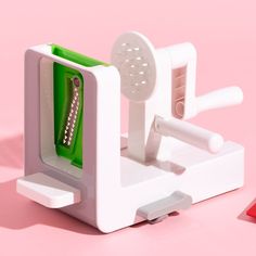 a close up of a toothbrush holder on a pink background