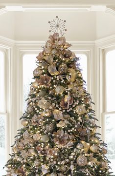 a decorated christmas tree with gold and silver ornaments