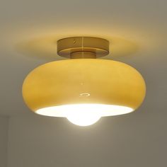 a light that is on the ceiling in a room with white walls and flooring