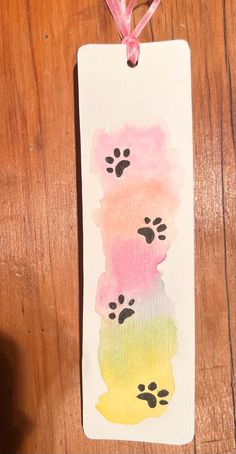 a watercolor bookmark with paw prints on it