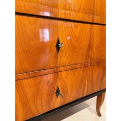 a wooden dresser with metal handles and knobs