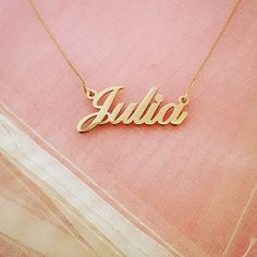 "Wear your name with pride with this stunning solid 14K gold necklace! Order any name in this pretty script typeface up to 8 letters. The biggest difference between our necklace and competitors is that ours is REAL gold. It is NOT gold filled OR gold plated, it is SOLID 14k gold - both the nameplate AND the chain! All of our gold is hand stamped for authenticity so you know that you are getting a trusted jewelry product. Name hangs picture style on a solid gold box chain (1 gram of gold) in 14\" Nameplate Necklace Gold, Real Gold Chains, Script Typeface, Picture Style, Gold Name Necklace, Gold Gifts, Gold Box, 14k Gold Necklace, Chain Extenders