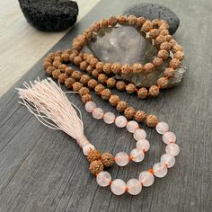 A most have addition to your Mala Necklace collection. A knotted mala with a mix of rose quartz beads and Rudraksha beads with a light pink tassel at the bottom. A stylish necklace that will also keep you grounded. Use it as a necklace, as a bracelet, even as a decor item in your room, or praying/ meditating area. The mala is 47cm- 18.5 inch drop length (without the tassel) The bottom tassel is 7.5cm- 3 inch long. The perfect gift for your loved ones. ⚡️Join Akashi's VIP list for early bird disc Rudraksha Necklace, Yoga Lover Gift, Knotted Mala, Rudraksha Beads, Karma Necklace, Necklace Collection, Pink Tassel, Rare Stone, Rose Quartz Necklace