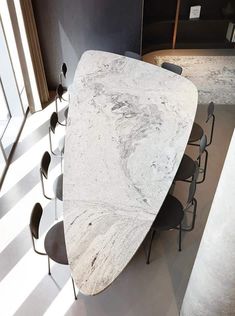 a white marble table with chairs around it