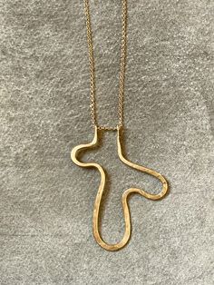 Cat Luck of Collarbone Jewelry works between her studio in Pittsburgh and a shared studio in NYC. Inspired by the raw aesthetics of the natural world, Luck is visual storyteller, using the alchemy of pure and mixed metals to create striking pieces that speak volumes. "Pinched Squiggle" hammered brass pendant a 30" 14K gold-filled chain. Pendant measures 2 1/4" long Cheap Handmade Brass Necklaces, Wire Chain Links, Brass Jewelry Design, Hammered Metal Jewelry, Brass Pendant Necklace, Hammered Jewelry, Metalsmithing Jewelry, Jewelry Words, Hammered Brass