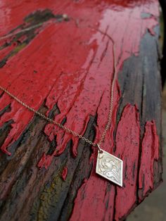 This sweet sterling silver pendant is an adorable everyday statement peice! It features beautiful hand-engraved swirls on a fun diamond shape made out of sterling silver.  Individual pieces may vary slightly from the pictured item. We make each piece by hand, one at a time, for every order. Because of this, your final piece may vary slightly from the picture and the engraving style may be adjusted slightly to fit your ring size or customizations. Please allow at least 5 to 6 weeks for shipment. Stamped Sterling Silver Pendant Jewelry, White Gold Etched Pendant Jewelry, Sterling Silver Etched Pendant Jewelry, Engraved Sterling Silver Charm Necklaces In White Gold, White Gold Sterling Silver Necklaces With Engraving Option, Engravable Sterling Silver White Gold Necklaces, White Gold Sterling Silver Necklace With Engraving Option, Engraved White Gold Sterling Silver Charm Necklaces, Dainty Engraved White Gold Charm Necklaces