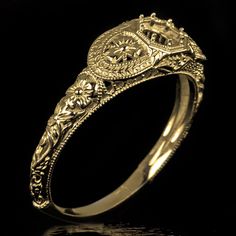 a gold ring with an intricate design on it