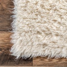 a white rug is laying on top of a wooden floor and it looks like something out of space