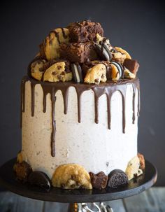 a cake with cookies and chocolate drizzled on top