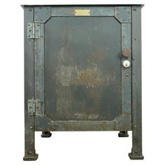 an old metal cabinet with rivets and knobs on the doors is isolated against a white background