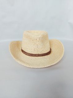 Stylis Cowboy Raffia Fedora Hat  Handmade with care, this hat is made from 100% natural fibers The hat features a beautiful braided lace decoration, adding a touch of elegance to any outfit.  It is also lightweight and breathable, ensuring comfort even on hot summer days.  The wide brim provides excellent sun protection, shielding your face and neck from harmful UV rays. The reguilin tied into the brim helps the hat maintain its shape, ensuring it looks stylish and put-together at all times.  Th Woven Sun Hat With Short Brim For Rodeo, Western Style Woven Straw Hats, Western Straw Fedora With Woven Detail, Woven Straw Panama Hat For Rodeo, Straw Woven Panama Hat For Rodeo, Wide Brim Woven Straw Hat For Rodeo, Brimmed Straw Ranch Hats, Woven Wide Brim Straw Hat For Rodeo, Western Style Short Brim Woven Straw Hat