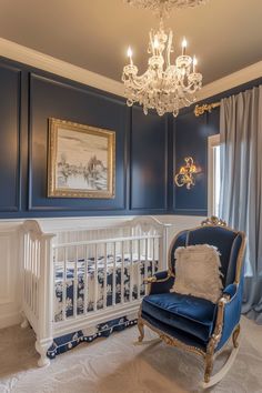 a baby's room with blue walls and chandelier