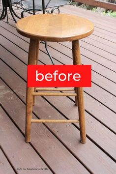 a wooden chair sitting on top of a wooden floor next to a table with a red sign that reads before