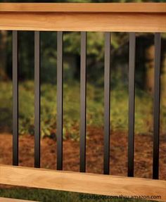 a wooden bench sitting on top of a lush green field