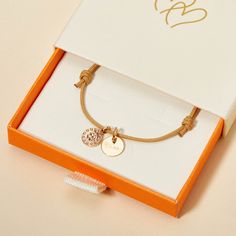 For a wish of luck and love, give our Personalized Clover Bracelet as a thoughtful keepsake to cherish. Personalize this bracelet with a special name or heartfelt word to create a keepsake full of meaning.&nbsp;18K Champagne Gold PlatedMini flat disc: 0.4 Diameter, 0.02 ThicknessClover Charm: 0.35Braid made of a durable, colorfast polyesterFully adjustable sliding knot fasteningHand-engraved in our Paris workshopSent with love in a complimentary gift boxAny slight variations in lettering depth, spacing and alignment from the examples shown are part of the aesthetic and originality of the piece Crystal Dice, Clover Bracelet, Clover Charm, Grandmother Gifts, Engraved Bracelet, Crystal Stars, Sliding Knot, Champagne Gold, Gifts For New Moms