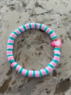 a close up of a bracelet on a beach