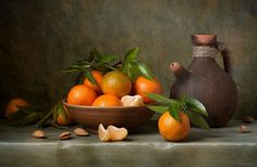 an oil painting of oranges in a bowl next to a jug and almonds