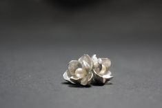 -Product description- Handmade sterling silver (925) jasmine earrings. The inner surface of the petal was carefully hand textured to be shimmery. While the outer layer was smooth and shiny, to give a beautiful contrast. A freshwater pearl was then attached to give an elegant touch. Great as a gift for her, or a treat for yourself. It is about 17mm (11/16 inch) in diameter, weighing 3.3 g (0.12oz). The ear post is 11mm(7/16 inch). Ear post can be customized to ear wire upon request. Please feel f Silver Petal-shaped Earrings For Gift, Silver Pearl Drop Flower-shaped Earrings, Silver Sterling Flower Earrings With Pearl Drop, Silver Flower Earrings With Pearl Drop, Silver Sterling Pearl Drop Flower Earrings, Silver Petal Flower Earrings For Gift, Silver Sterling Earrings With 3d Flowers, Sterling Silver Earrings With 3d Flowers, Sterling Silver Flower Pearl Drop Earrings