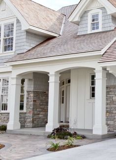 a house with white trim and gray shingles