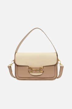 Introducing our Lexi Top Handle Bag - a perfect blend of style and functionality for the modern equestrian. Crafted from premium vegan leather in a warm & neutral palette, this versatile purse transitions effortlessly from a chic crossbody to a grab-on-the-go mini. Featuring an iconic horse bit detail in gold. The top flap opens from the back with a magnetic snap closure. Fully lined interior with substantial main compartment to hold all of your evening and everyday essentials. 8" L x 5" H x 3" Beige Flap Bag With Adjustable Strap For On-the-go, Cream Shoulder Bag With Gold-tone Hardware For Work, Versatile Bags With Gold-tone Hardware For Fall, Versatile Beige Top Handle Flap Bag, Elegant Beige Saddle Bag With Adjustable Strap, Beige Flap Bag With Gold-tone Hardware For Work, Elegant Beige Saddle Bag For Everyday, Chic Saddle Bag With Gold-tone Hardware For Travel, Everyday Trendy Saddle Bag With Gold-tone Hardware