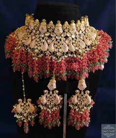 an elaborate necklace and earrings on display