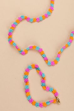 an orange, blue and pink beaded dog leash