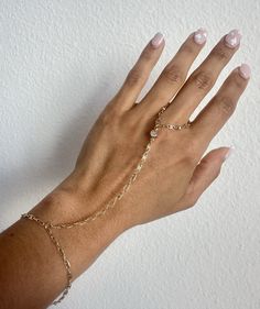 Hand Chain Ring Bracelet, CZ Stone, Rolo Link Chain, Bridal Dainty Bracelet, Finger Link Ring Chain, Mothers day 2024 gift Description: * Material: 18K Gold Filled * Quantity: Finished Bracelet * Length: Bracelet Size (6 3/4' Inch) + 2" EXT * Length (Wrist to finger): 4' Inch * Thickness: 2mm * Color: Gold **HOW TO CARE FOR YOUR JEWELRY *Maintain your jewelry's high shine by avoiding contact with any chemicals such as soap, perfume, lotion, makeup, hair & cleaning products. *When you do not use the jewelry you bought, you can always keep it in a pouch or box, reducing its contact with oxygen and wearing it for many years with its first day's shine. *You can do your product maintenance with a cotton-soft dry cloth. *You can always be stylish with the products you keep in the boxes sent to y Adjustable Round Body Jewelry For Wedding, Adjustable Chain Bracelet For Wedding, Delicate Gold Body Jewelry As Gift, Delicate Adjustable Gold Body Jewelry, Delicate Gold Body Jewelry Gift, Delicate Gold Body Jewelry For Gift, Personalized Adjustable Promise Jewelry, Resizable Rose Gold Bracelet, Dainty Jewelry With Adjustable Chain