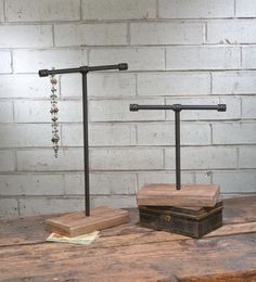 two wooden boxes sitting on top of a wooden table next to a lamp and chain