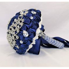 a bridal bouquet with blue satin flowers and crystal stones