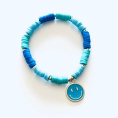 - Smiley Face is approx 1/2" diameter- Smiley Face is made of metal- Colorful beads are made of clay (feel almost like rubber)- Bracelets made on heavy duty elastic for easy on and off Trendy Adjustable Heishi Beads, Blue Beaded Bracelets With Heart Beads For Friendship, Adjustable Blue Stretch Bracelet With Heart Beads, Trendy Turquoise Heishi Beads Jewelry, Fun Blue Beaded Bracelets For Gifts, Fun Blue Bracelets For Gifts, Blue Heart Beads Jewelry For Friendship, Adjustable Blue Bracelets With Heart Beads, Adjustable Heishi Beads Jewelry With Large Beads