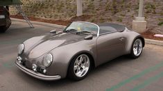 a gray sports car parked in a parking lot