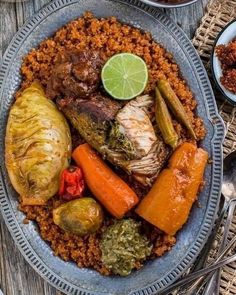 a plate filled with meat, rice and vegetables