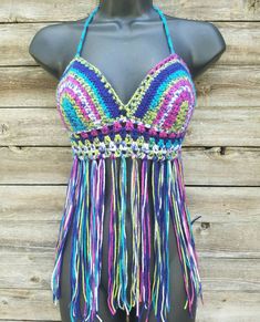 This super comfortable crochet bikini top is perfect for lounging at your favorite summer festival. It is made with 100% acrylic yarn in varying rainbow colors of lime green, pink, dark purple, and blue. Laces up the back and ties around the neck. Custom made to fit your size and measurements. Want padding added? Add this listing to your order and choose from either push up or regular foam padding. https://www.etsy.com/listing/399021473/add-padding-to-your-crochet-top Festival Crochet Stretch Swimwear, Bohemian Multicolor Crochet Swimwear, Bohemian Fitted Swimwear For Festival, Bohemian Fitted Festival Swimwear, Beachy Crochet Top For Festival, Multicolor Stretch Crochet Top For The Beach, Multicolor Stretch Crochet Top For Beach, Hippie Triangle Halter Top For Festivals, Fitted Purple Crochet Top For Vacation