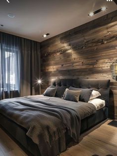 a bedroom with wooden walls and flooring is lit up by lights on either side of the bed