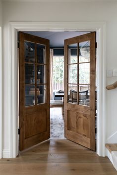 an open wooden door leading to a dining room