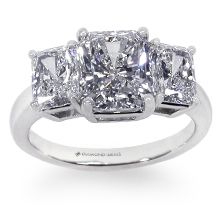 three stone engagement ring with princess cut diamonds on the shoulders and sides, set in 18k white gold