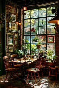 a dining room with lots of windows and plants on the table in front of it