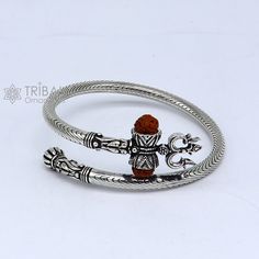 Vintage antique design handmade 925 sterling silver amazing rudraksha beads bahubali shiva trident trishool kada bangle bracelet, excellent gifting jewelry from Rajasthan india. Metal-925 Sterling silver. Item type-Bangle/Bracelet/kada Weight-35.570 grams approx. Width-5.mm bangle size size-adjustable by twisting it.(inner diameter-6.0 cm)2-6(we can easily wear bigger size like 2-8) Stamped-925. finish-Oxidized. Excellent gifting jewelry Adjustable Silver Jewelry For Puja, Symbolic Jewelry For Navratri Puja, Symbolic Jewelry For Puja And Navratri, Symbolic Jewelry For Navratri Rituals, Silver Bracelet Jewelry For Diwali, Spiritual Bangle For Puja, Spiritual Oxidized Jewelry For Navratri, Spiritual Jewelry With Intricate Design For Navratri, Navratri Spiritual Jewelry With Intricate Design