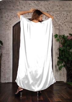 This long bottom cut kaftan is made up of satin material. A caftan is a perfect addition to any women’s wardrobe. It can be worn day into night, as a stunning swimsuit cover-up at the beach, as well as a glamorous evening dress Made from airy silk, it is cool and airy, and great for warm weather. this kaftan gives classy touch to your body line while carrying it. You can pair it with any kind of accessories at any occasion. You can carry it for the whole day without any trouble and fuss. This li Long Satin Kaftan For Evening, Evening Satin Maxi Kaftan, Satin Maxi Length Evening Kaftan, Evening Satin Maxi Length Kaftan, Long Satin Kaftan For Eid, Evening Satin Floor-length Kaftan, Elegant Long Satin Kaftan, Eid Satin Maxi Dress, Satin Maxi Kaftan For Party