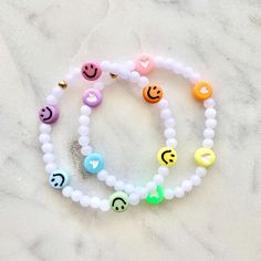 Kids Hearts or Smilies Rainbow Stretch Bracelet Choose your size and your accent charm (heart or smiley)  All beads are acrylic Listing is for ONE bracelet but you can add more than one to your cart.  ** Contact me if you have any questions! ** Rainbow Bracelet Clay Beads, White Novelty Stretch Bracelet With Round Beads, Novelty White Stretch Bracelet With Round Beads, Trendy White Heart Charm Bracelet, Trendy White Charm Bracelet With Letter Beads, Plastic Heart Beads Jewelry For Gifts, Trendy White Charm Bracelet For Valentine's Day, Playful White Jewelry With Heart Beads, Fun White Beaded Bracelets With Heart Beads