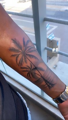 a person with a palm tree tattoo on their arm