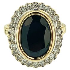 This Art Deco Cocktail Gold Ring is a magnificent statement piece that exudes luxury and sophistication. Crafted in the iconic French style, it embodies the timeless elegance and exquisite craftsmanship synonymous with Art Deco French jewelry design. At the heart of the ring is a breathtaking 6.30-carat sapphire bezel-set, a gemstone prized for its rich color and timeless beauty. The sapphire takes center stage, commanding attention with its intense hue and exceptional clarity. Surrounding the s French Jewelry, Style Français, Bezel Setting, Cocktail Rings, Timeless Beauty, Rich Color, Statement Pieces, Gold Rings, Gold Tones