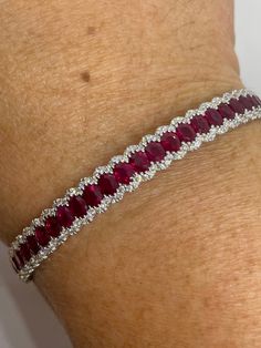 Stunning Ruby and Diamond Bangle Bracelet White Gold. These are fine quality genuine rubies are well matched and full of life. Excellent craftsmanship the diamonds are very sparkling. Very smooth finish, won't catch on things. This classy bangle bracelet is one that you will treasure for a lifetime. This is an heirloom piece. Almost 7mm width. Bangle measures 58x51mm. The push lock comes with safety latch for a secure fit. One Only! Genuine earth mined red rubies Total weight: 5.93 carats Genuin Ruby Diamond Bracelet, Unique Wedding Jewelry, Ruby Bangles, Diamond Bangle Bracelet, Diamond Bracelet Design, Ruby Bracelet, Gold Diamond Band, Diamond Bangles Bracelet, Bangles Jewelry Designs