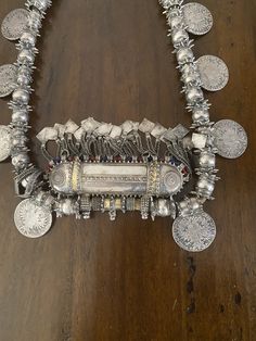 "Here is an amazing, original necklace from Oman. It measures approximately 37 3/4\" (95,8 cm) long. The main pendant measures 4 5/8\" (11,75 cm) long and ~ 5 3/4\" (14,6 cm) wide. This is wonderful vintage piece, in great shape commensurate with age and tribal use. It features gorgeous workmanship. It is strung on its original cotton cording. The darker material on the loop side is from incense, often applied to jewelry from this region. This piece is truly massive and weighs in at just over 71 Traditional One-of-a-kind Necklaces For Ceremonial Occasions, Traditional One Of A Kind Necklaces For Ceremonial Occasions, Traditional Ceremonial Necklaces, Traditional One-of-a-kind Necklace For Festival, Antique Beaded Pendant Necklace, Traditional Temple Necklace With Coin Pendant, One-of-a-kind Medallion Necklace For Festivals, Handmade Amulet Coin Necklace, Traditional Silver Necklace With Coin Pendant