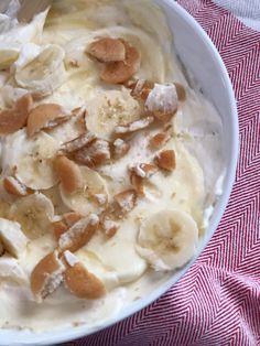 a bowl filled with bananas and nuts on top of a table