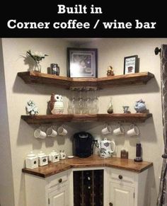 a corner coffee bar with wine glasses on the top and shelves above it that are built into the wall