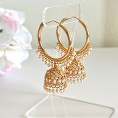 "Add a glamourous twist to your ordinary golden hoops with these classic bali jhumkas! These earrings come in a beautiful golden color with colored contrasting beads embellishing the hoops. Perfect for your casual occasions without going over the top! Length: 2.5\" | Width 1.5\" Items are carefully packed and ready for gifting. All pictures are taken in natural light please allow for slight variations in color due to camera settings. Jewelry Care ✨Protect your jewelry in a closed box or pouch   ✨Wear jewelry after you have applied lotion or perfume ✨Gently buff with a soft cotton cloth  Visit our website: www.desimoon.etsy.com Thank you for visiting and hope you enjoy my shop!" Golden Jhumka Earrings, Cheap Chandbali Earrings With Latkans, Cheap Chandbali Bridal Earrings For Wedding, Small Jumkas For Daily Use, Affordable Festive Temple Jewelry Earrings, Jumkha Earrings Gold, Cheap Chandbali Earrings For Festivals, Jhumka Earrings Gold, Cheap Bridal Earrings For Wedding And Diwali